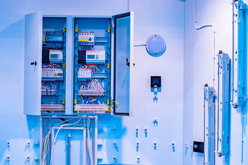 Open electrical cabinet at the enterprise. Utility room. Cabinet with electric wires and counters....