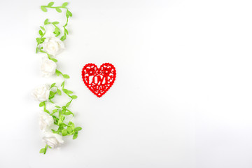 red heart shape which engrave into letter love in white rose vine frame , image for valentine and wedding concept