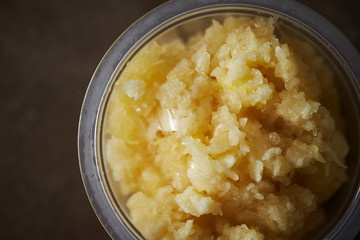 Crushed garlic in plastic bowl 