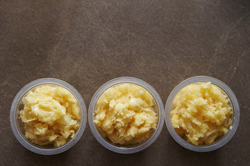 Crushed garlic in plastic bowl 