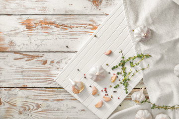 Fresh garlic with spices and herbs on table