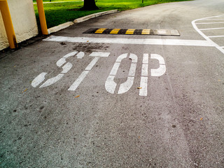 Fototapeta premium Stop Sign on Asphalt with a Speed Bump
