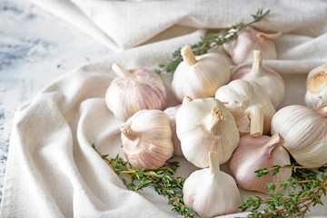 Fresh garlic with herbs on table
