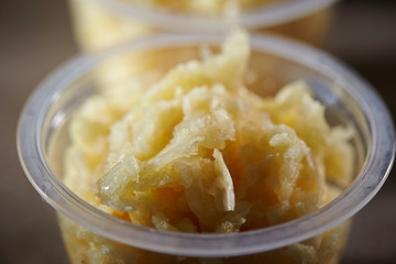 Crushed garlic in plastic bowl 