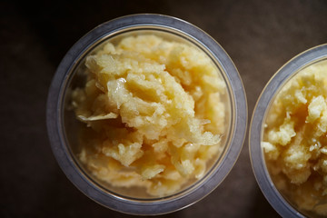 Crushed garlic in plastic bowl 