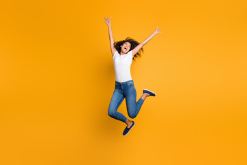 Fototapeta na wymiar Full length body size view of her she nice attractive crazy cheerful wavy-haired girl jumping motivation having fun inspiration isolated over bright vivid shine vibrant yellow color background