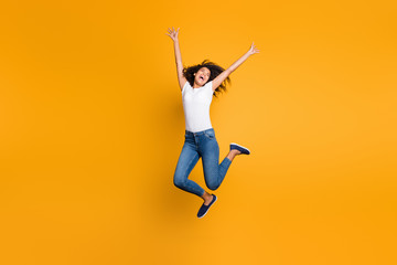 Full length body size view of her she nice attractive crazy cheerful wavy-haired girl jumping motivation having fun inspiration isolated over bright vivid shine vibrant yellow color background