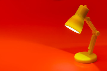 Desk lamp on red