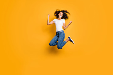 Full length body size photo of cheerful screaming shouting rejoicing overjoyed girl having won big prize wearing jeans denim white t-shirt isolated vivid color background