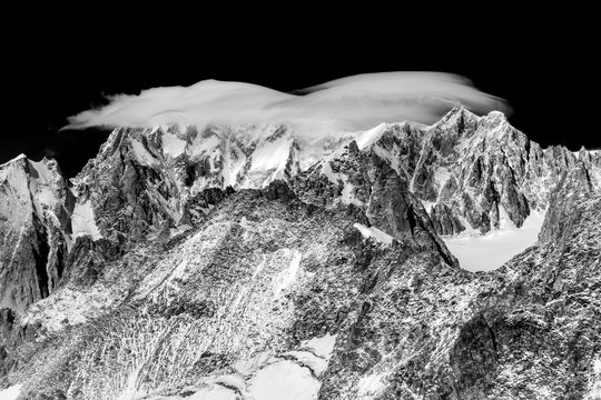 Top of Mont Blanc wrapped in lenticular cloud, Aosta valley, Italy, Europe