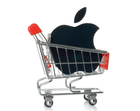 KIEV, UKRAINE - JANUARY 16, 2015: Apple logotype printed on paper and placed into shopping cart. Apple is an American multinational corporation, that sells consumer electronics and personal computers.