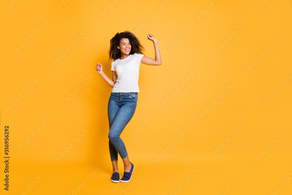 Wall mural Full length body size photo of cheerful casual positive cute nice pretty sweet girlfriend wearing jeans denim footwear dancing with eyes closed isolated over vivid color background