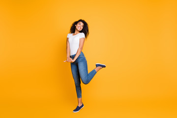 Fototapeta na wymiar Full length body size view of her she nice attractive lovely charming cheerful cheery girlish shy wavy-haired girl posing having fun isolated over bright vivid shine vibrant yellow color background