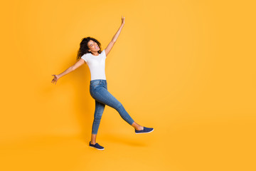 Fototapeta na wymiar Full length body size turned photo of cheerful pretty crazy dancing girl wearing white t-shirt jeans denim footwear isolated over vivid color background