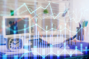 Obraz premium Financial graph displayed on woman's hand taking notes background. Concept of research. Multi exposure
