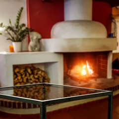 Winter background of wooden table and fireplace 