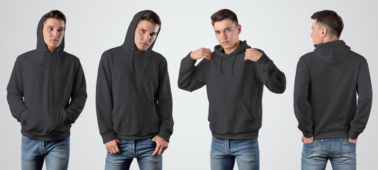 Mockup of a male black hoodie on a young guy on an isolated background, set with a pose in front...