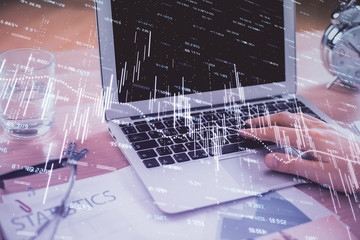 Multi exposure of market chart with man working on computer on background. Concept of financial analysis.