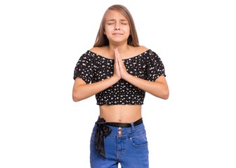 Portrait of teen girl praying, isolated on white background. Cute caucasian teenager with hands folded in prayer hoping for better. Child asking God for good luck, success or forgiveness.