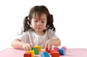 Little curly asian girl enjoy playing toy at home. Education Concept.