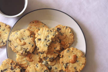 coffee break and chocolate cookie on white plate
