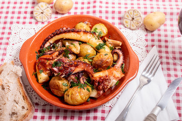Grilled ocotpus with potatoes, garlic and salsa.