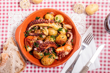 Grilled ocotpus with potatoes, garlic and salsa.