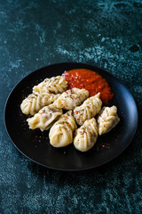 Georgian Dumplings Khinkali with Meat, Tomato Sauce and Spices / Hingel.