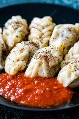 Georgian Dumplings Khinkali with Meat, Tomato Sauce and Spices / Hingel.