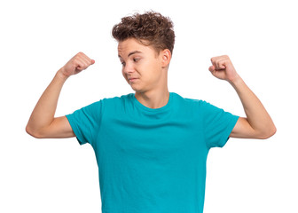 Portrait of funny teen boy raised his hands and shows biceps, isolated on white background. Handsome teenage young boy shows biceps. Weak child flexing biceps.