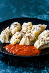 Georgian Dumplings Khinkali with Meat, Tomato Sauce and Spices / Hingel.
