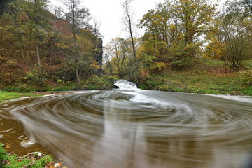 Autumn slow flowing water in a creek