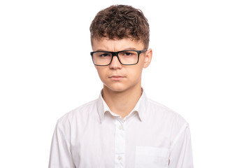 Portrait of upset teen boy with eyeglasses, isolated on white background. Child looking tired and bored. Handsome caucasian young teenager with depression problems.