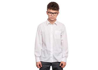 Fototapeta premium Portrait of upset teen boy with eyeglasses, isolated on white background. Child looking tired and bored. Handsome caucasian young teenager with depression problems.