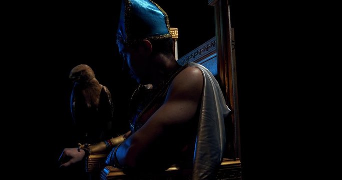 Ancient egyptian pharaoh wearing traditional clothes is sitting on a throne, 4k