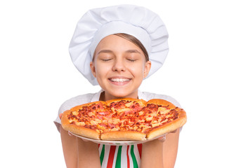 Happy beautiful teen girl in chef hat holding cooked pizza. Girl cook in apron holds plate with fresh pizza, isolated on white background. Portrait of cute child showing delicious Italian pizza.