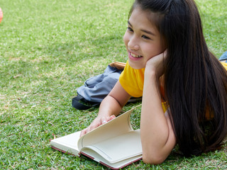 Young woman reading book in the park