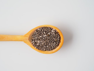 Chia seeds isolated on white background in the spoon.