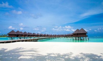 Beautiful tropical Maldives island with beach. Sea with water bungalows