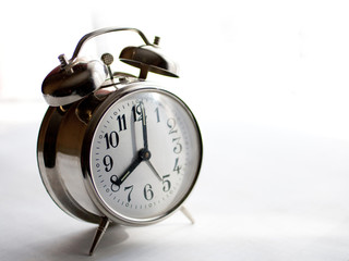 Vintage alarm clock isolated on white background