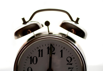 Vintage alarm clock isolated on white background