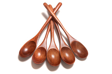 wooden spoons over white background