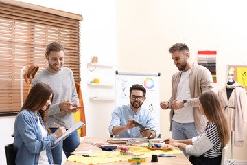 Fashion designers creating new clothes in studio