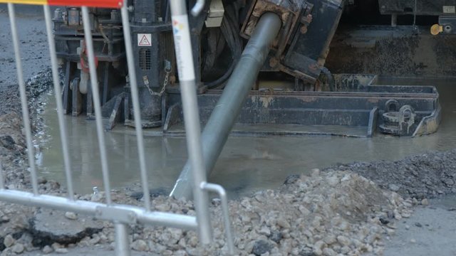 Directional horizontal drill rig drilling under city street asphalt
