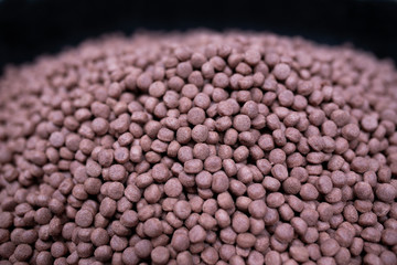 Brown pet food texture, Close up of a pile of dog kibble.