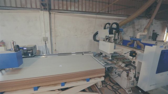 Edgebander machine. People work on edgebanding machine. Single sided automatic edge bander on factory.