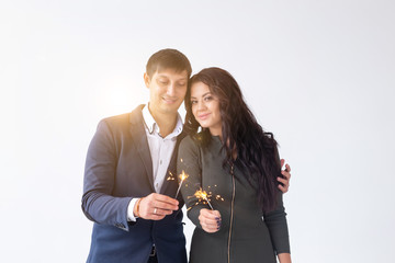 Valentines day and date concept - Couple with sparklers on white background