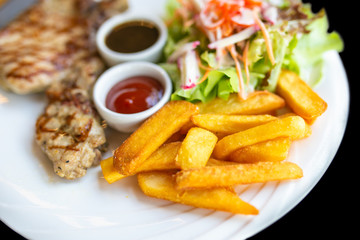 Grilled meat, Porkchops steak with pepper sauce and salad.