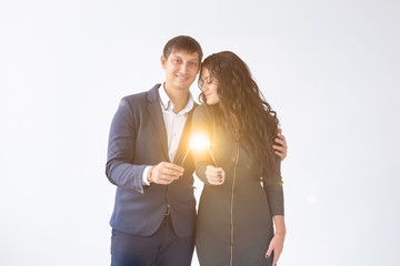 Valentines day and date concept - Couple with sparklers on white background