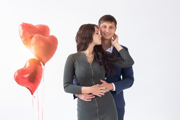 Holidays and relationship concept - Young couple on Valentine's Day on white background
